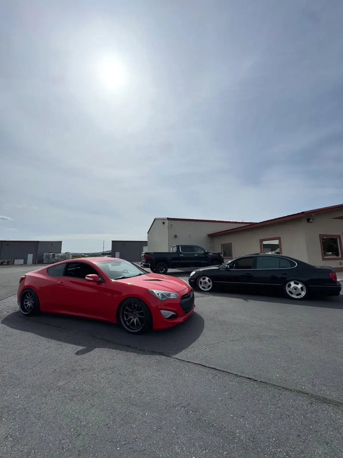 Red Genesis Coupe and black Lexus GS in the lot